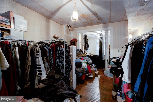 walk in closet with hardwood / wood-style floors