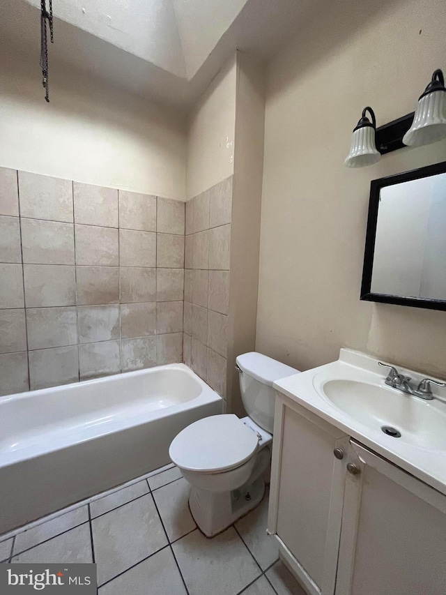 full bathroom featuring tile flooring, toilet, vanity, and tiled shower / bath