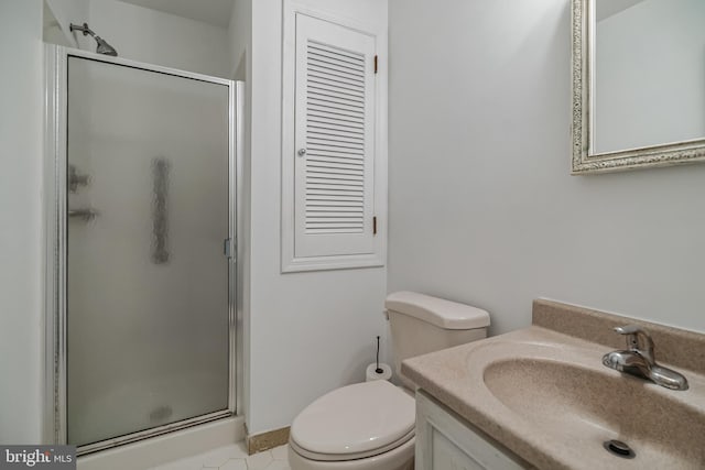 bathroom with vanity, a shower with door, tile patterned floors, and toilet