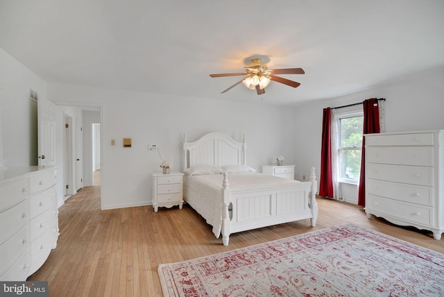 bedroom with ceiling fan and wood-type flooring