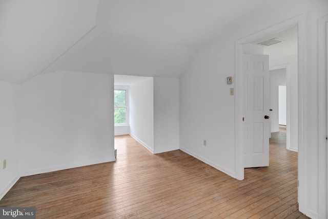 bonus room featuring hardwood / wood-style flooring and vaulted ceiling