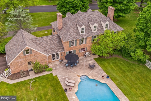 view of swimming pool featuring a patio area and a lawn