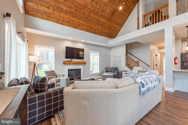 living room featuring wood ceiling, dark wood-type flooring, and high vaulted ceiling