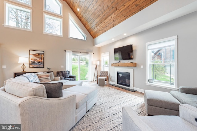 living room with wood ceiling, high vaulted ceiling, hardwood / wood-style flooring, and a high end fireplace