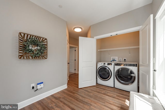 clothes washing area with hardwood / wood-style floors, hookup for a washing machine, hookup for an electric dryer, and washing machine and clothes dryer