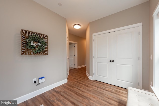 unfurnished bedroom with a closet and hardwood / wood-style flooring