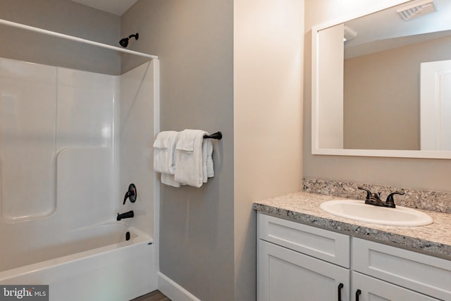 bathroom featuring shower / tub combination and vanity