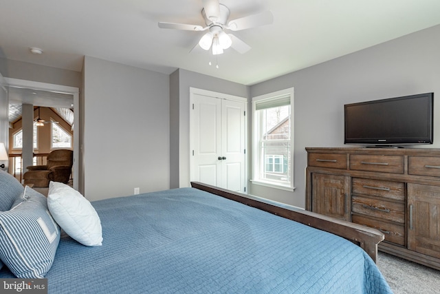 carpeted bedroom featuring a closet and ceiling fan