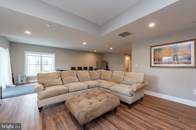 living room featuring wood-type flooring and radiator heating unit