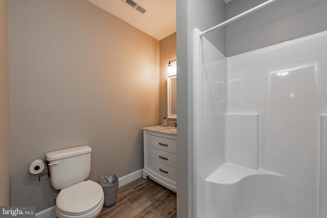 bathroom featuring wood-type flooring, vanity, and toilet