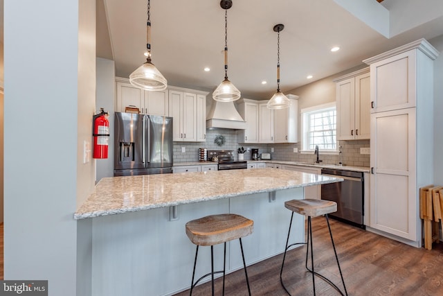 kitchen with stainless steel appliances, dark wood-type flooring, custom exhaust hood, and white cabinetry