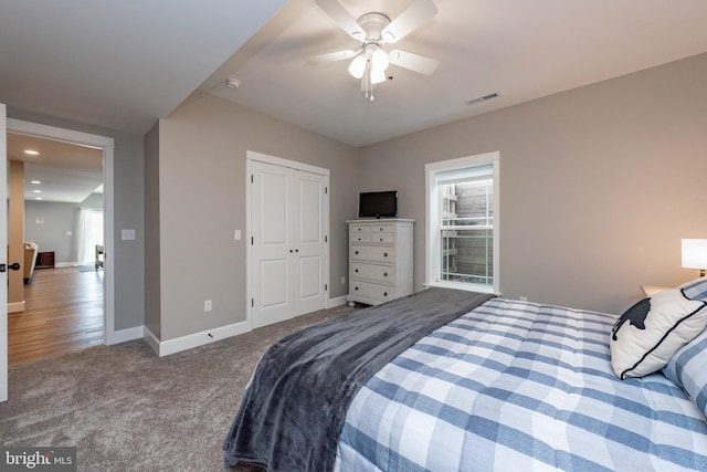 bedroom with a closet, ceiling fan, carpet flooring, and multiple windows