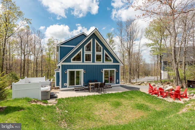 back of house with a yard and a patio