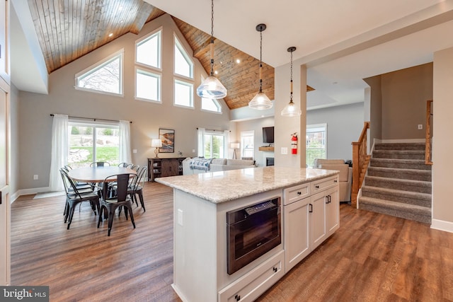 kitchen featuring wood ceiling, a wealth of natural light, pendant lighting, and hardwood / wood-style flooring