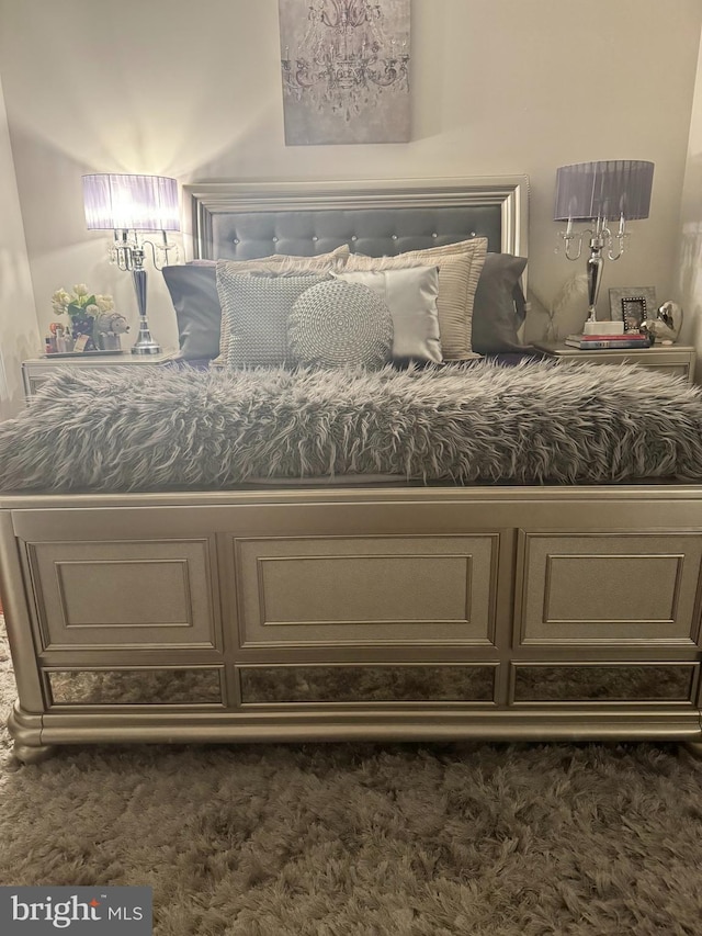 bedroom featuring dark carpet