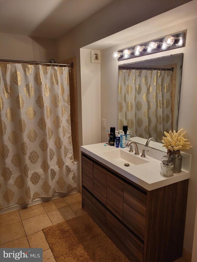 bathroom with tile floors and vanity