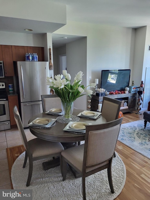 dining space with light tile floors