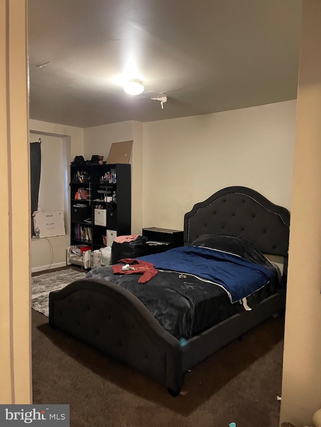 bedroom featuring dark carpet