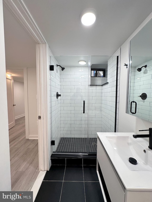 bathroom with vanity, hardwood / wood-style flooring, and an enclosed shower