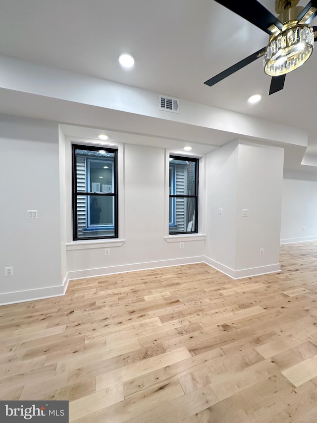 unfurnished room featuring ceiling fan and light wood-type flooring