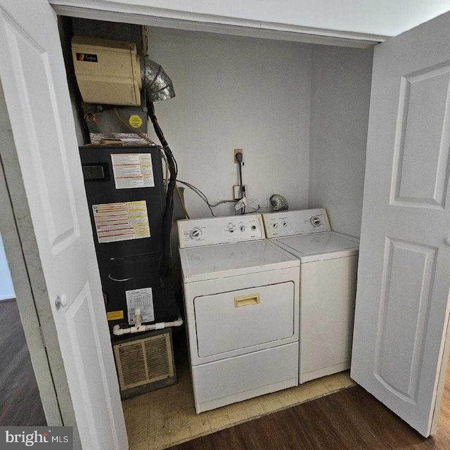 washroom featuring dark hardwood / wood-style floors and washer and dryer