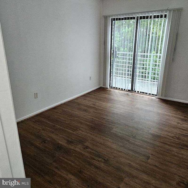 empty room with dark wood-type flooring