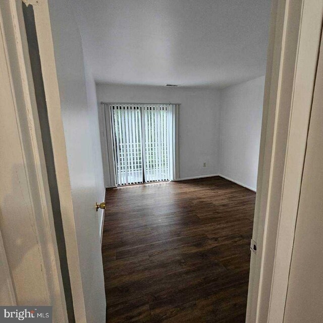 laundry area featuring washing machine and dryer and dark hardwood / wood-style flooring