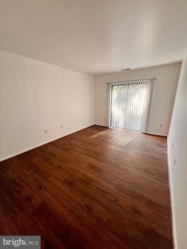 spare room featuring dark hardwood / wood-style flooring