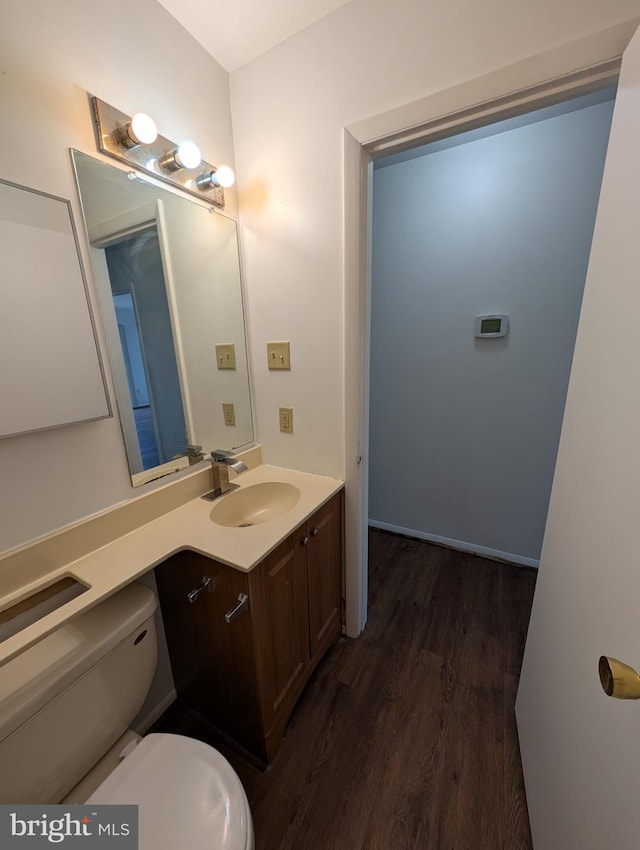 bathroom with vanity, wood-type flooring, and toilet