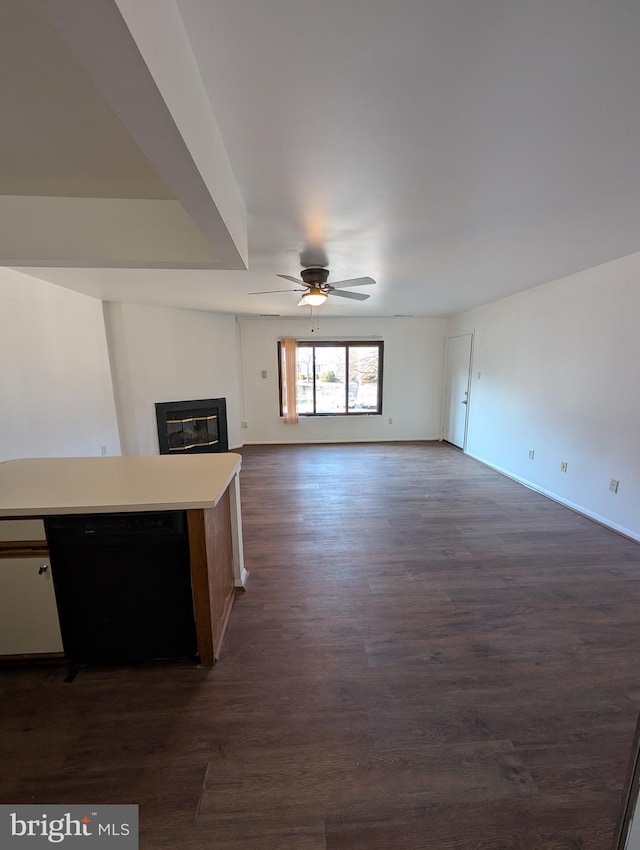 unfurnished living room with ceiling fan and dark hardwood / wood-style flooring