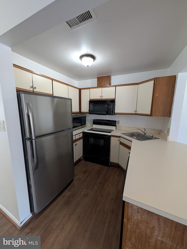 kitchen featuring sink, black appliances, and dark hardwood / wood-style floors