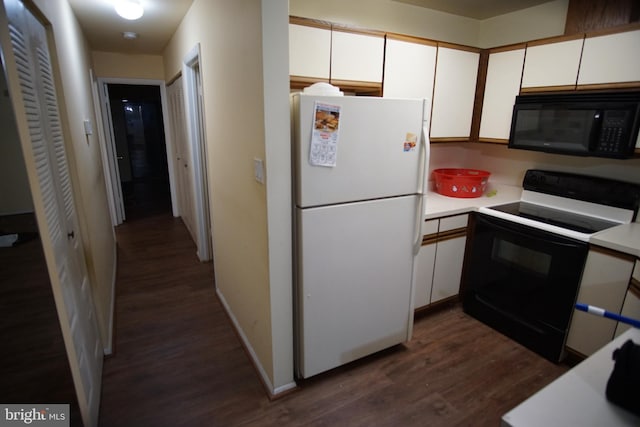 kitchen with white cabinetry, black appliances, and dark hardwood / wood-style floors