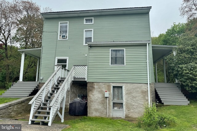 rear view of property with a yard