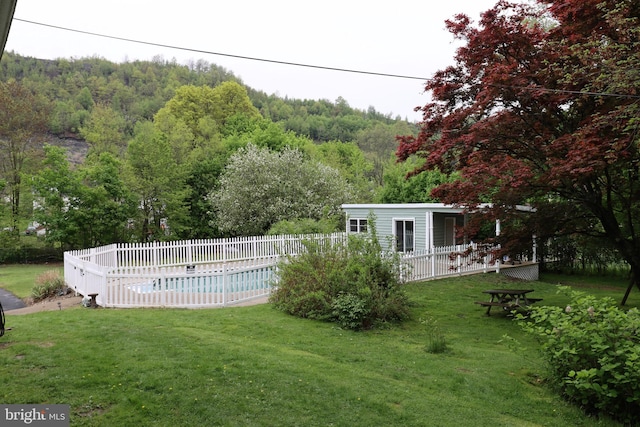 view of yard with a fenced in pool