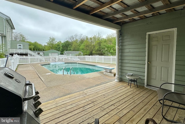 view of pool featuring a patio area and a diving board