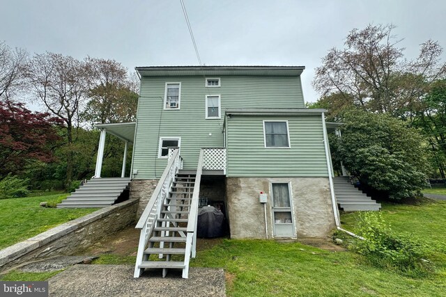 rear view of house featuring a yard