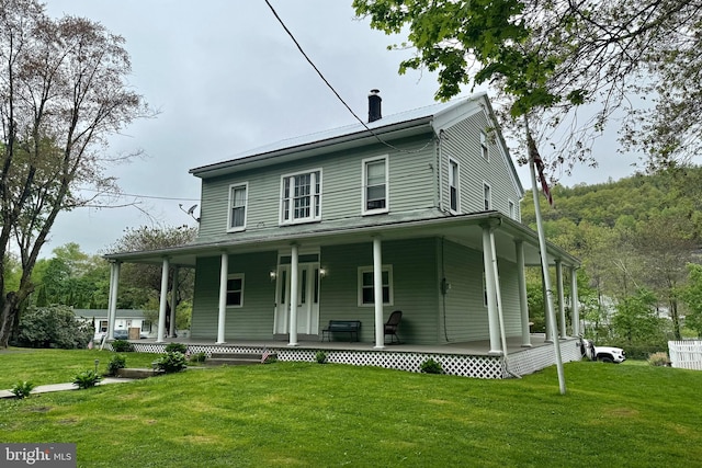 farmhouse with a porch and a front yard