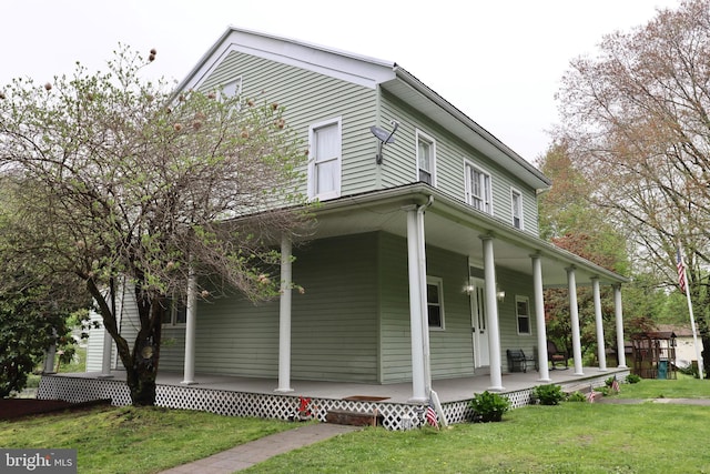 view of home's exterior featuring a porch and a lawn