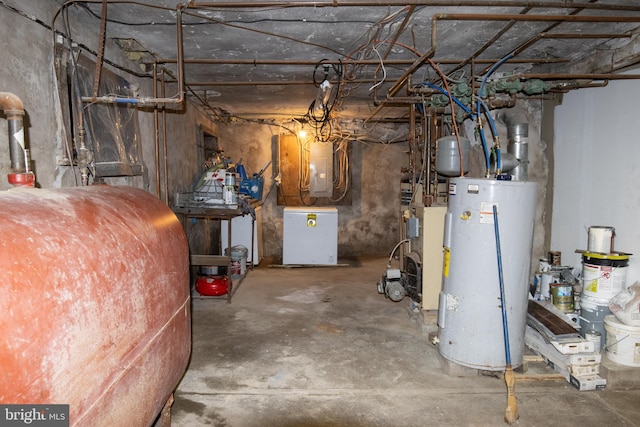 basement with water heater, electric panel, and refrigerator