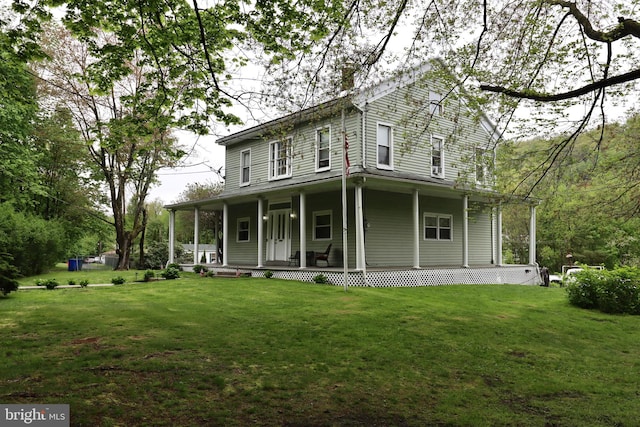 view of front of house featuring covered porch and a front yard