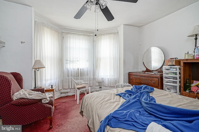 carpeted bedroom featuring ceiling fan and multiple windows