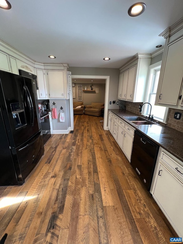 kitchen with white cabinets, sink, tasteful backsplash, dark wood-type flooring, and black appliances