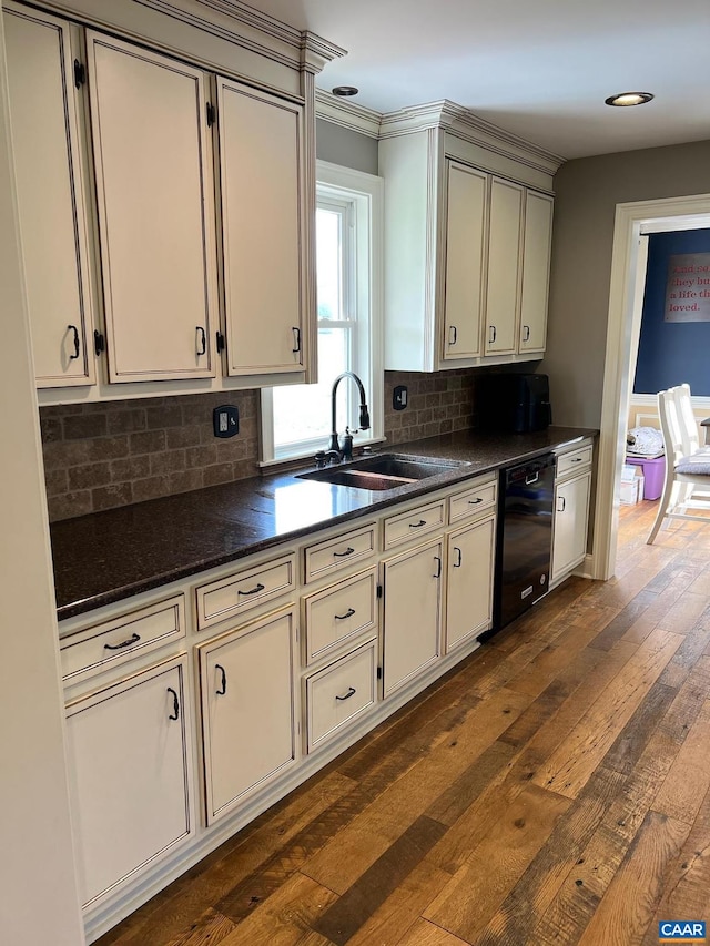 kitchen featuring backsplash, sink, dark hardwood / wood-style flooring, and dishwasher