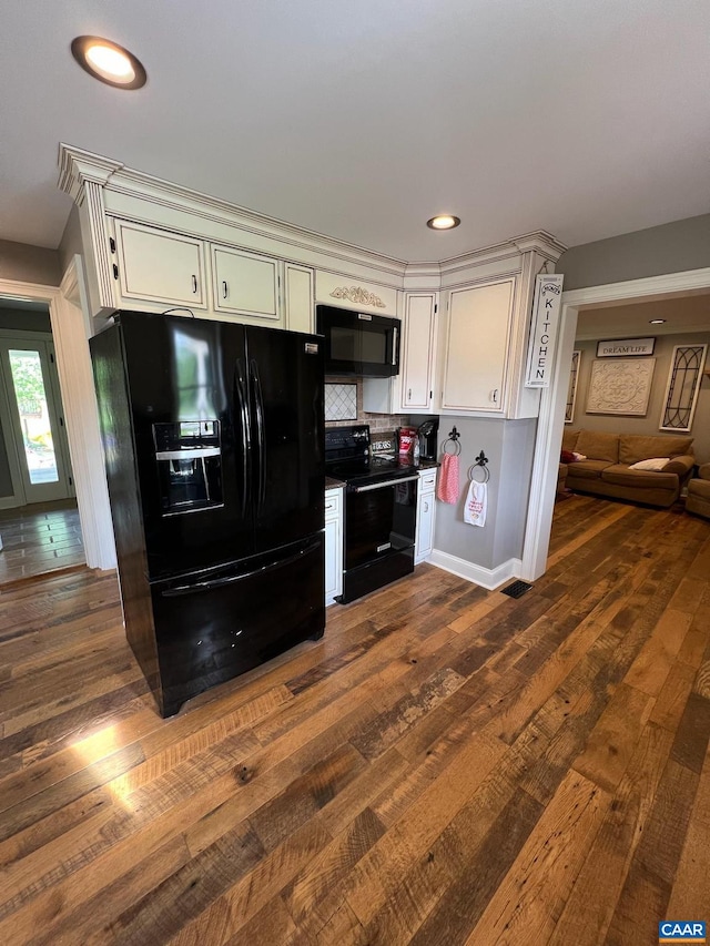 kitchen with black appliances, backsplash, white cabinetry, and dark hardwood / wood-style floors