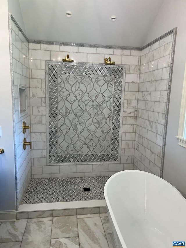 bathroom with vaulted ceiling, shower with separate bathtub, and tile flooring