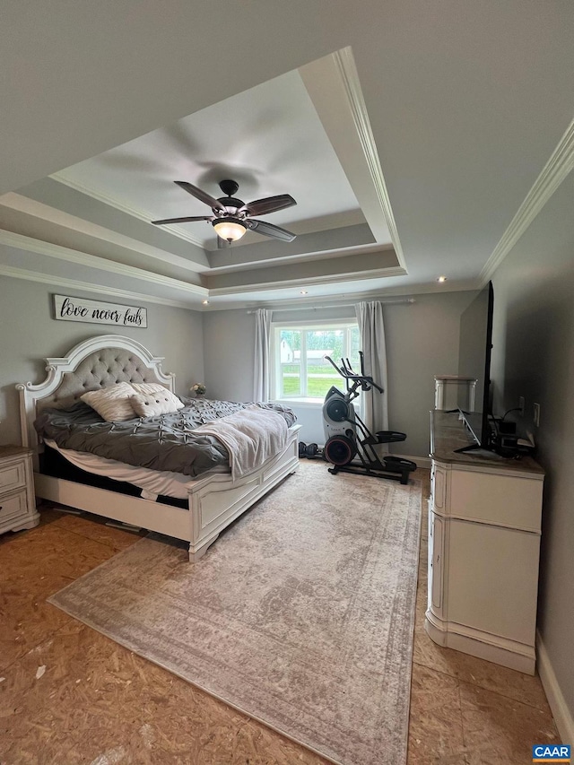 bedroom featuring ornamental molding, ceiling fan, and a tray ceiling