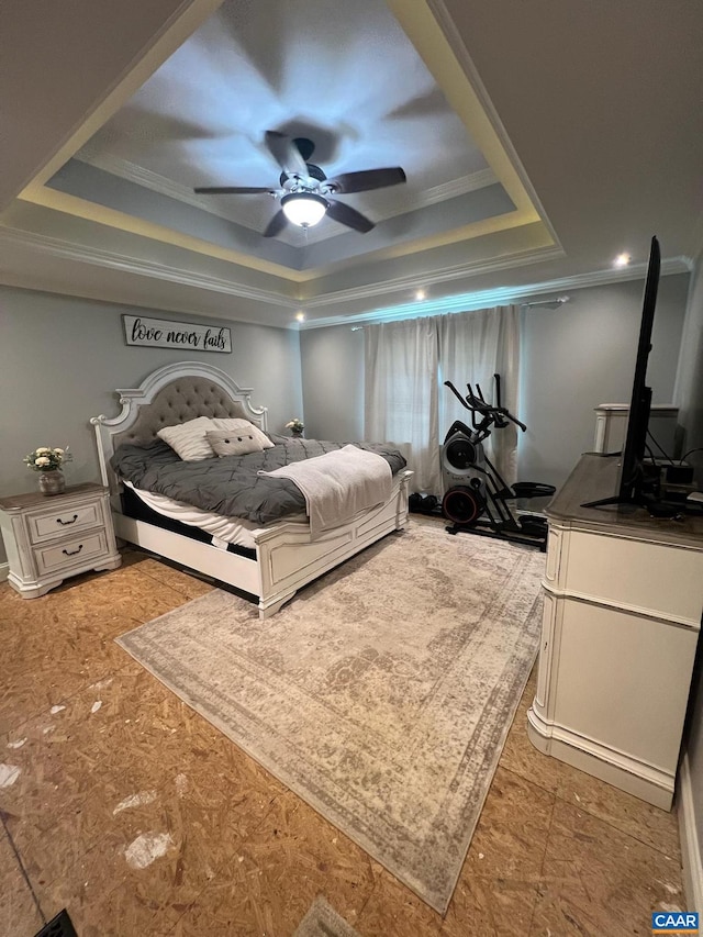 bedroom with crown molding, ceiling fan, and a tray ceiling