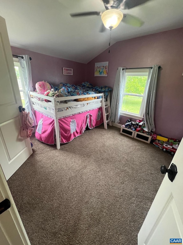 carpeted bedroom with ceiling fan and vaulted ceiling