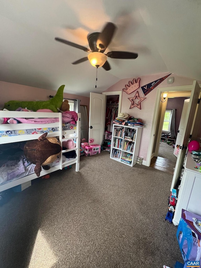 bedroom featuring lofted ceiling, carpet floors, and ceiling fan