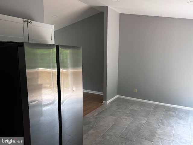 empty room featuring lofted ceiling and light hardwood / wood-style flooring